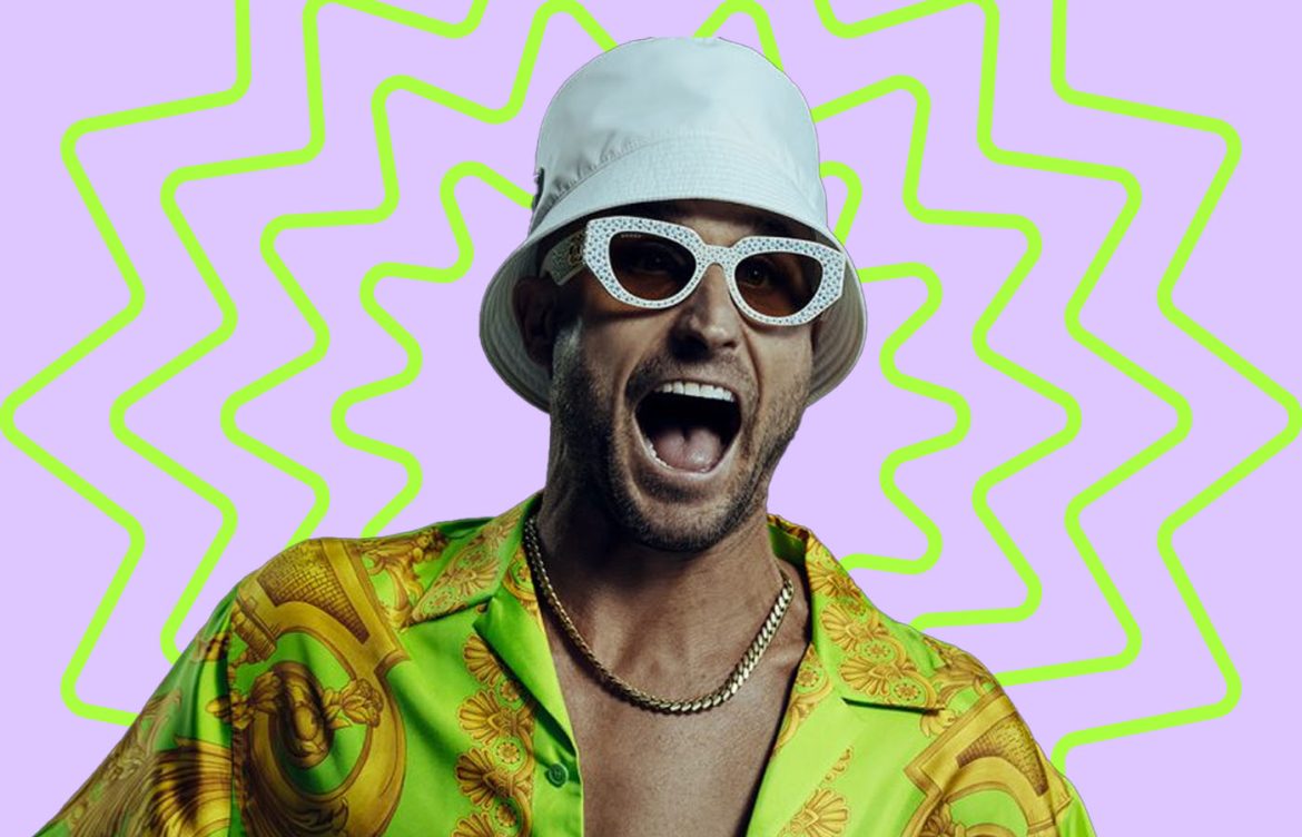 A man in a white bucket hat yelling playfully against a colorful background
