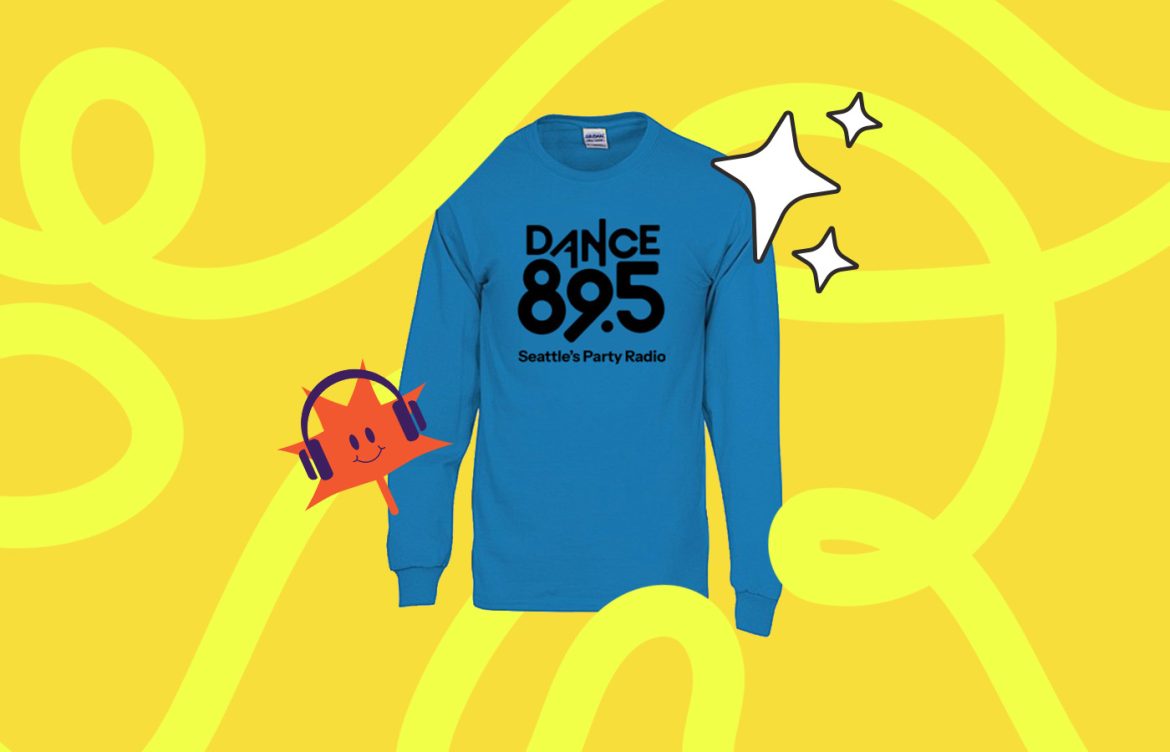 A blue long-sleeve shirt featuring the text "DANCE 89.5 Seattle's Party Radio" in bold black letters. The background is bright yellow with swirling patterns, a red smiling star wearing headphones, and two white sparkling star graphics.